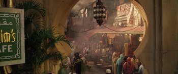 Movie still from “Keeping Up with the Joneses” (2016), directed by Greg Mottola – A crowd of people walking through a market area; Extreme Wide shot, High angle