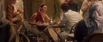 Movie still from “Keeping Up with the Joneses” (2016), directed by Greg Mottola – A woman and a man sitting at a table with food; Medium shot, Over the shoulder angle