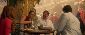 Movie still from “Keeping Up with the Joneses” (2016), directed by Greg Mottola – A man and a woman sitting at a table with a tea pot; Medium shot, Over the shoulder angle