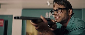 Movie still from “The Last Rampage” (2017), directed by Dwight H. Little – A man holding a nintendo wii controller in his hand; Close Up shot, Over the shoulder angle