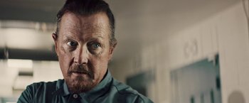 Movie still from “The Last Rampage” (2017), directed by Dwight H. Little – A person wearing a shirt; Close Up shot, Over the shoulder angle