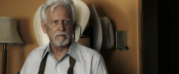 Movie still from “The Last Rampage” (2017), directed by Dwight H. Little – An older man wearing a white shirt and a tie; Close Up shot, Over the shoulder angle