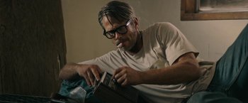 Movie still from “The Last Rampage” (2017), directed by Dwight H. Little – A man smoking a cigarette while holding a cell phone; Close Up shot, Low angle