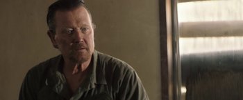 Movie still from “The Last Rampage” (2017), directed by Dwight H. Little – A person wearing a shirt; Close Up shot, Over the shoulder angle