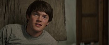 Movie still from “The Last Rampage” (2017), directed by Dwight H. Little – A person wearing a gray shirt; Close Up shot, Over the shoulder angle