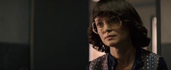 Movie still from “The Last Rampage” (2017), directed by Dwight H. Little – A woman wearing glasses looking at the camera; Close Up shot, Over the shoulder angle