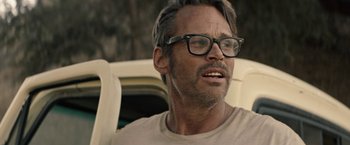 Movie still from “The Last Rampage” (2017), directed by Dwight H. Little – A person wearing glasses on a car seat; Close Up shot, Over the shoulder angle
