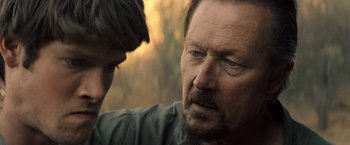 Movie still from “The Last Rampage” (2017), directed by Dwight H. Little – A person and a man with a beard; Close Up shot, Over the shoulder angle