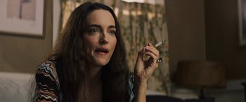 Movie still from “The Last Rampage” (2017), directed by Dwight H. Little – A woman is holding a cigarette in her hand; Close Up shot, Over the shoulder angle