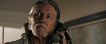 Movie still from “The Last Rampage” (2017), directed by Dwight H. Little – An older man holding a phone up to his ear; Close Up shot, Low angle