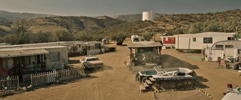 Movie still from “The Last Rampage” (2017), directed by Dwight H. Little – A group of cars parked in a dirt field; Extreme Wide shot, High angle