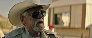 Movie still from “The Last Rampage” (2017), directed by Dwight H. Little – An older man wearing a cowboy hat and sunglasses; Close Up shot, Over the shoulder angle