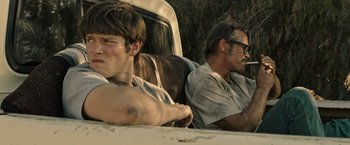 Movie still from “The Last Rampage” (2017), directed by Dwight H. Little – Two men sitting in the back of a white truck; Close Up shot, Over the shoulder angle