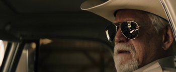 Movie still from “The Last Rampage” (2017), directed by Dwight H. Little – An older man wearing a cowboy hat and sunglasses; Close Up shot, Over the shoulder angle