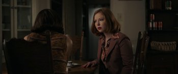 Movie still from “The Last Rampage” (2017), directed by Dwight H. Little – A woman sitting at a wooden table in front of another woman; Medium shot, Over the shoulder angle