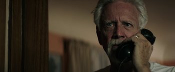 Movie still from “The Last Rampage” (2017), directed by Dwight H. Little – An older man with a gray beard is looking at the camera; Close Up shot, Low angle