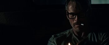 Movie still from “The Last Rampage” (2017), directed by Dwight H. Little – A man with glasses is holding a lit candle; Close Up shot, Low angle
