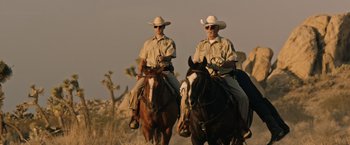 Movie still from “The Last Rampage” (2017), directed by Dwight H. Little – A couple of men riding on the backs of horses; Wide shot, Low angle