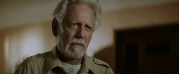 Movie still from “The Last Rampage” (2017), directed by Dwight H. Little – An older man with a white beard and a white mustache; Close Up shot, Low angle