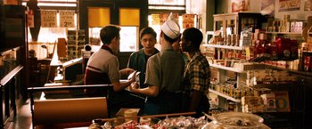 Movie still from “Last Vegas” (2013), directed by Jon Turteltaub – A group of young men standing around in a store; Medium shot, High angle
