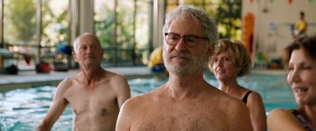 Movie still from “Last Vegas” (2013), directed by Jon Turteltaub – A man with a white beard and glasses in front of two other men; Close Up shot, Over the shoulder angle