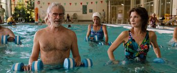 Movie still from “Last Vegas” (2013), directed by Jon Turteltaub – A group of people in a swimming pool; Medium shot, Over the shoulder angle