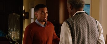 Movie still from “Last Vegas” (2013), directed by Jon Turteltaub – A man standing next to another man in a room; Medium shot, Over the shoulder angle