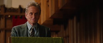 Movie still from “Last Vegas” (2013), directed by Jon Turteltaub – A man in a suit and tie standing in front of a podium; Close Up shot, Low angle