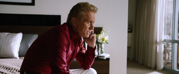 Movie still from “Last Vegas” (2013), directed by Jon Turteltaub – An older man sitting on the ground with his hand under his chin; Close Up shot, Over the shoulder angle