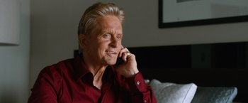 Movie still from “Last Vegas” (2013), directed by Jon Turteltaub – An older man talking on a cell phone while sitting down; Close Up shot, Low angle