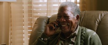 Movie still from “Last Vegas” (2013), directed by Jon Turteltaub – An older man talking on a cell phone while sitting in a chair; Close Up shot, Low angle