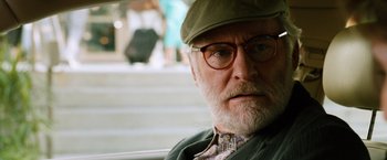 Movie still from “Last Vegas” (2013), directed by Jon Turteltaub – An older man wearing a hat and glasses looking at the camera; Close Up shot, Over the shoulder angle