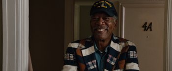 Movie still from “Last Vegas” (2013), directed by Jon Turteltaub – An older man wearing a hat and a jacket smiling; Close Up shot, Over the shoulder angle