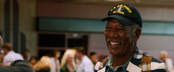 Movie still from “Last Vegas” (2013), directed by Jon Turteltaub – An older man wearing an air force hat and smiling; Close Up shot, Low angle