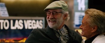 Movie still from “Last Vegas” (2013), directed by Jon Turteltaub – An older man wearing a green hat and glasses; Close Up shot, Over the shoulder angle