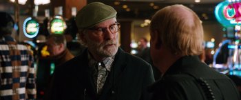 Movie still from “Last Vegas” (2013), directed by Jon Turteltaub – An older man wearing a green hat and glasses; Close Up shot, Over the shoulder angle