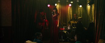 Movie still from “Last Vegas” (2013), directed by Jon Turteltaub – A woman in a red dress singing on a stage; Wide shot, High angle
