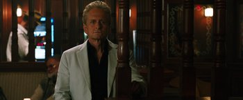 Movie still from “Last Vegas” (2013), directed by Jon Turteltaub – An older man in a white jacket standing next to a wooden post; Close Up shot, Low angle