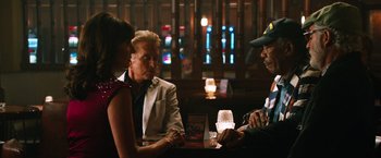 Movie still from “Last Vegas” (2013), directed by Jon Turteltaub – A group of people sitting at a table in front of a window; Medium shot, Over the shoulder angle
