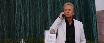Movie still from “Last Vegas” (2013), directed by Jon Turteltaub – An older man talking on a cell phone while standing next to a taxi stand; Close Up shot, Low angle