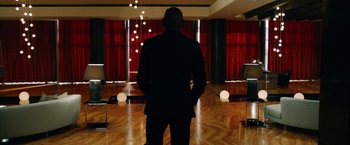 Movie still from “Last Vegas” (2013), directed by Jon Turteltaub – A man in a suit standing in front of red curtains; Wide shot, Low angle