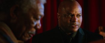 Movie still from “Last Vegas” (2013), directed by Jon Turteltaub – A man in a black suit and a black tie; Close Up shot, Over the shoulder angle