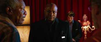 Movie still from “Last Vegas” (2013), directed by Jon Turteltaub – A man in a black suit and a tie; Medium shot, Over the shoulder angle