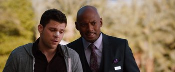 Movie still from “Last Vegas” (2013), directed by Jon Turteltaub – A man in a suit and tie standing next to another man in a suit; Close Up shot, Over the shoulder angle