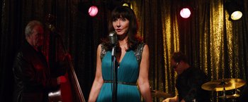 Movie still from “Last Vegas” (2013), directed by Jon Turteltaub – A woman in a blue dress holding a microphone; Medium shot, Over the shoulder angle