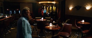 Movie still from “Last Vegas” (2013), directed by Jon Turteltaub – A group of people sitting at tables in a room; Wide shot, Over the shoulder angle