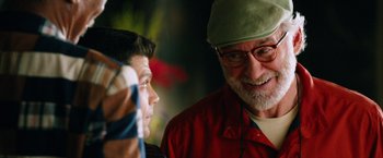 Movie still from “Last Vegas” (2013), directed by Jon Turteltaub – A man with a beard wearing a red shirt and a green hat; Close Up shot, Over the shoulder angle