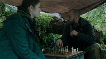Movie still from “Leave No Trace” (2018), directed by Debra Granik – A man and a woman playing a game of chess; Medium shot, Over the shoulder angle