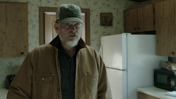Movie still from “Leave No Trace” (2018), directed by Debra Granik – An older man wearing a hat and a jacket; Medium shot, Over the shoulder angle