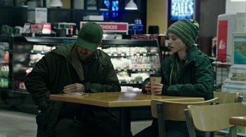 Movie still from “Leave No Trace” (2018), directed by Debra Granik – A man and a woman sitting at a table; Medium shot, Over the shoulder angle
